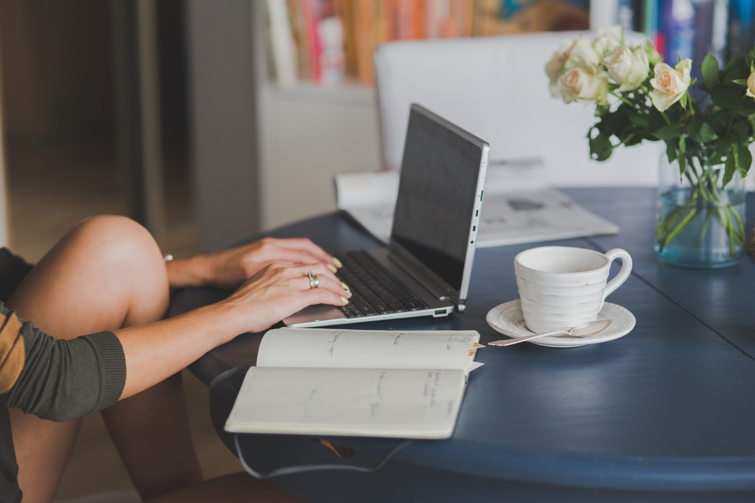 travel advisor planning a custom itinerary on laptop with notebook and coffee